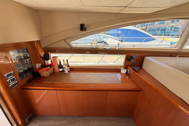 Slide: The Image of Luxurious interior of 2007 Viking Princess 54 Flybridge yacht with elegant wood finish and bar area. - 29