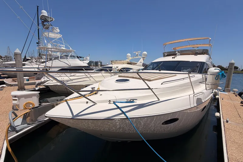 Slide: The Image of 2007 Viking Princess 54 Flybridge yacht docked at marina under clear blue sky. - 3