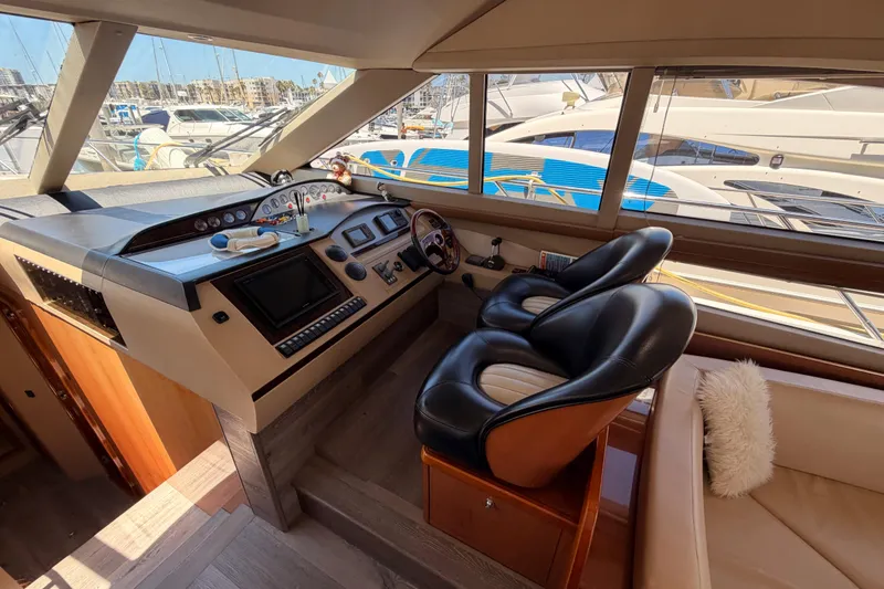 Slide: The Image of Luxurious 2007 Viking Princess 54 Flybridge yacht helm with plush seating and modern controls. - 32