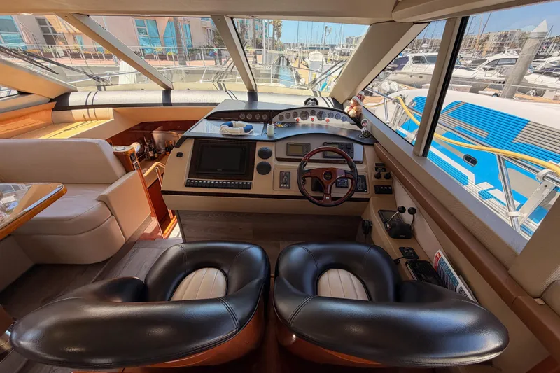 Slide: The Image of Luxurious 2007 Viking Princess 54 Flybridge yacht interior with modern helm and plush seating. - 33