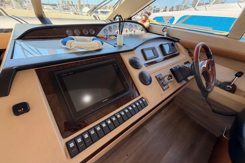 Slide: The Image of Helm of 2007 Viking Princess 54 Flybridge yacht with navigation controls and steering wheel. - 34
