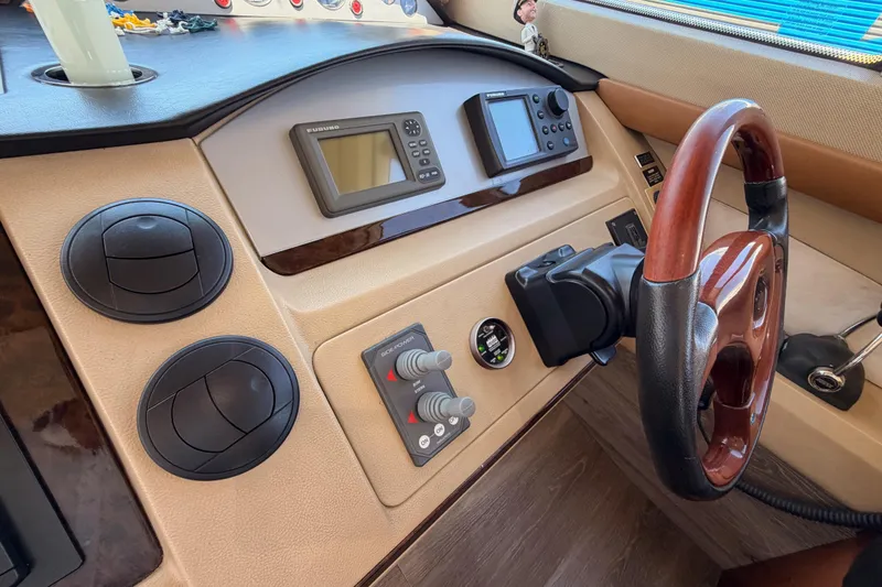 Slide: The Image of Helm of 2007 Viking Princess 54 Flybridge with navigation controls and wooden steering wheel. - 35