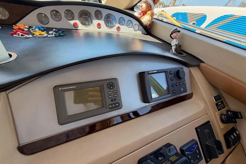 Slide: The Image of Dashboard of a 2007 Viking Princess 54 Flybridge with navigation equipment and decorative items. - 36
