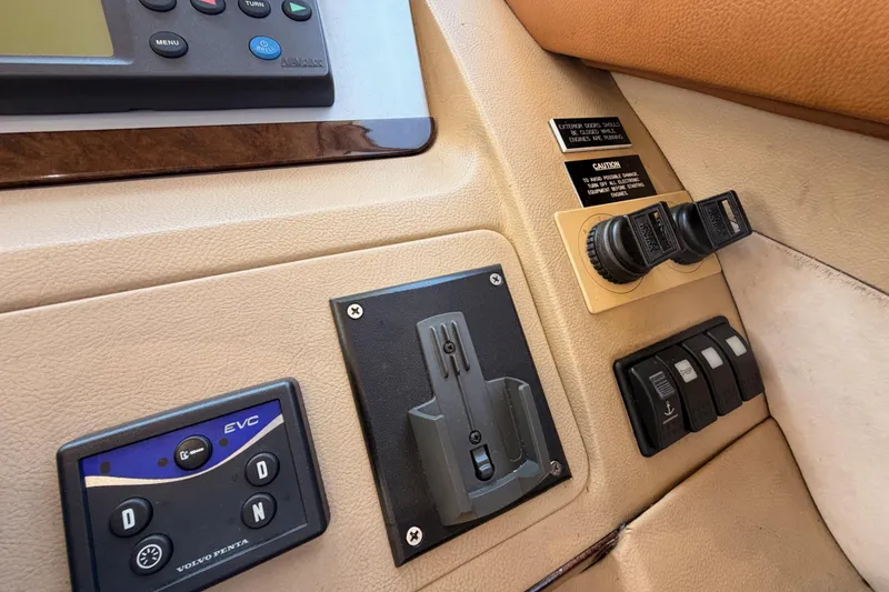 Slide: The Image of Control panel of a 2007 Viking Princess 54 Flybridge yacht, featuring switches and displays. - 37