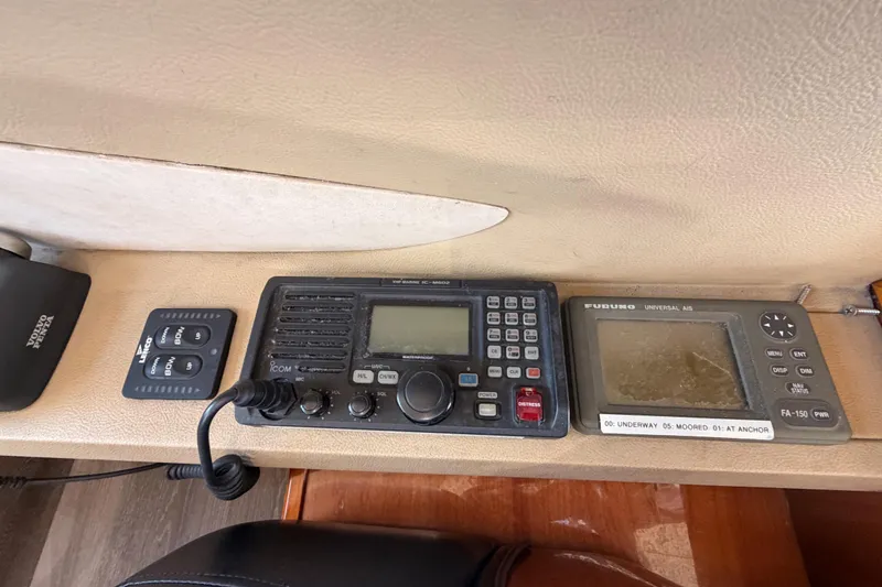 Slide: The Image of Control panel of a 2007 Viking Princess 54 Flybridge with communication and navigation equipment. - 38