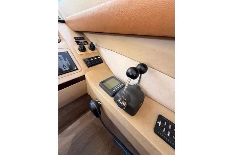 Slide: The Image of Control panel of 2007 Viking Princess 54 Flybridge yacht with throttle levers and display. - 39