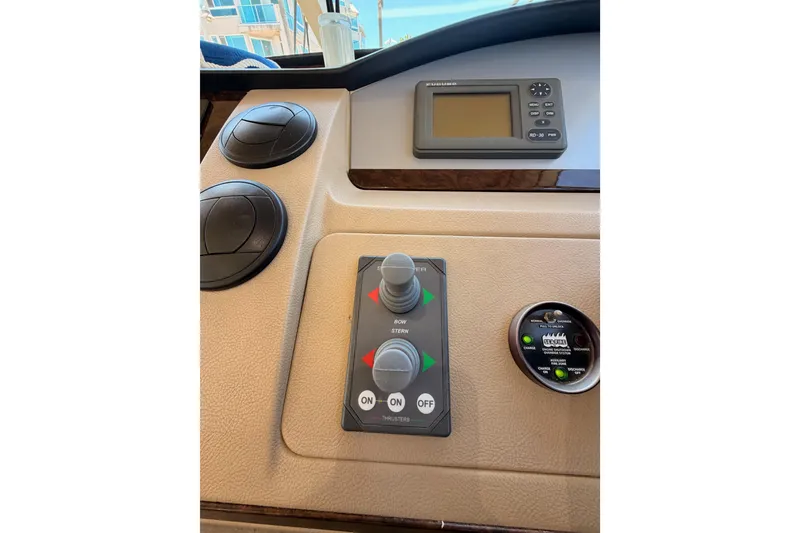 Slide: The Image of Control panel of a 2007 Viking Princess 54 Flybridge yacht, featuring navigation and thruster controls. - 40