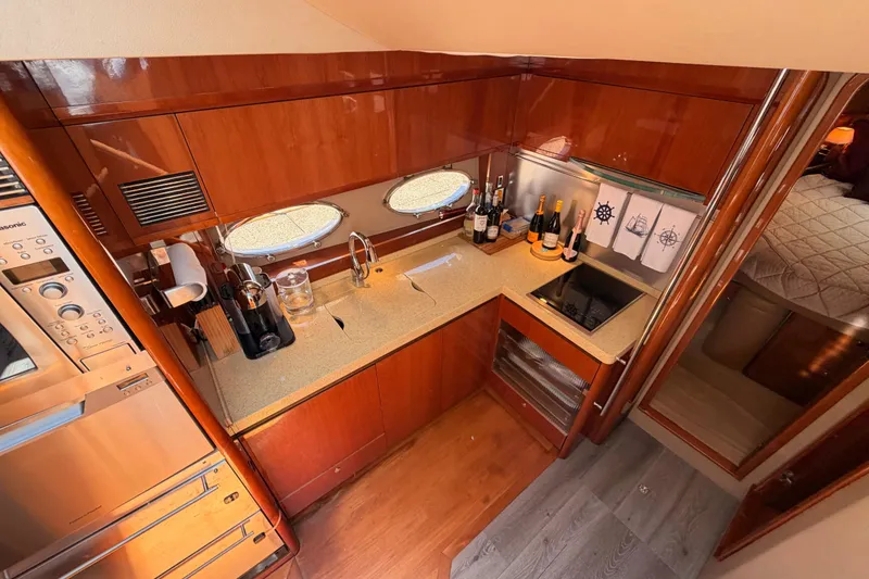 Slide: The Image of Luxurious galley in 2007 Viking Princess 54 Flybridge yacht with modern appliances and elegant wood finish. - 44