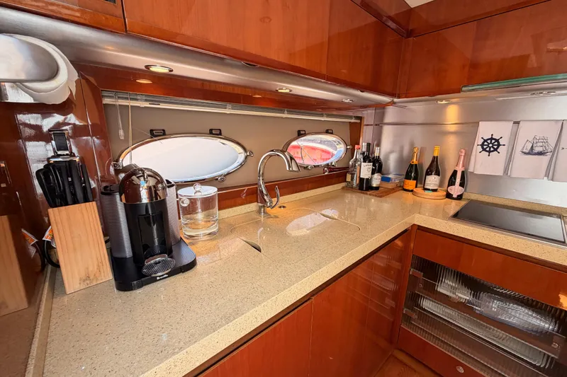 Slide: The Image of Luxurious 2007 Viking Princess 54 Flybridge yacht kitchen with modern amenities and elegant design. - 48