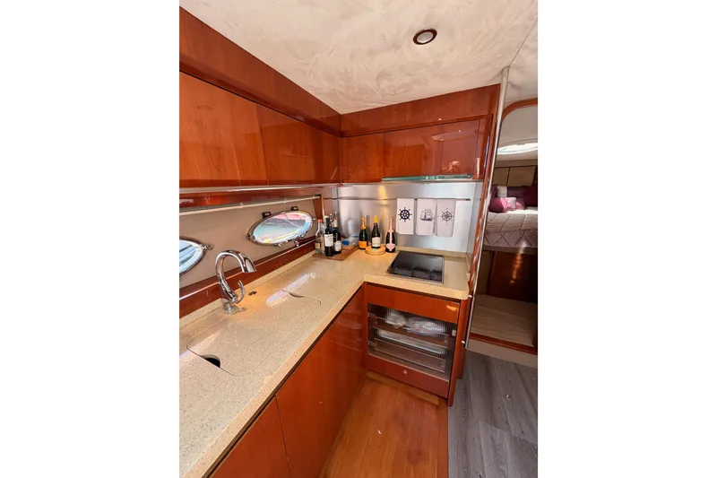 Slide: The Image of Luxurious galley in 2007 Viking Princess 54 Flybridge yacht with wood cabinetry and modern amenities. - 49