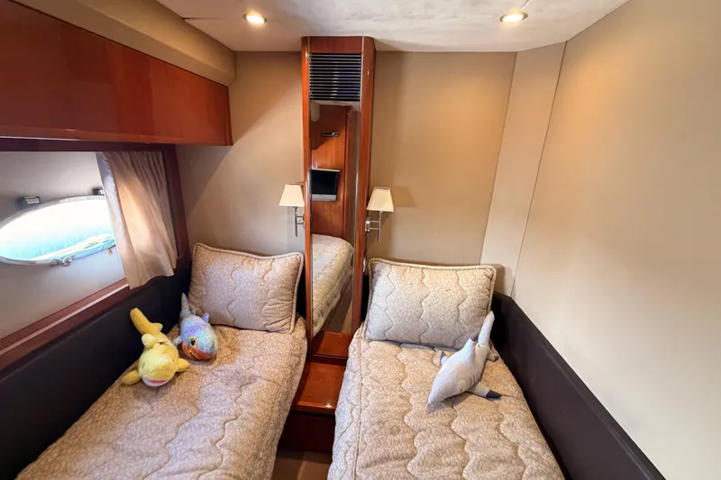 Slide: The Image of Luxurious 2007 Viking Princess 54 Flybridge cabin with twin beds and plush decor. - 52