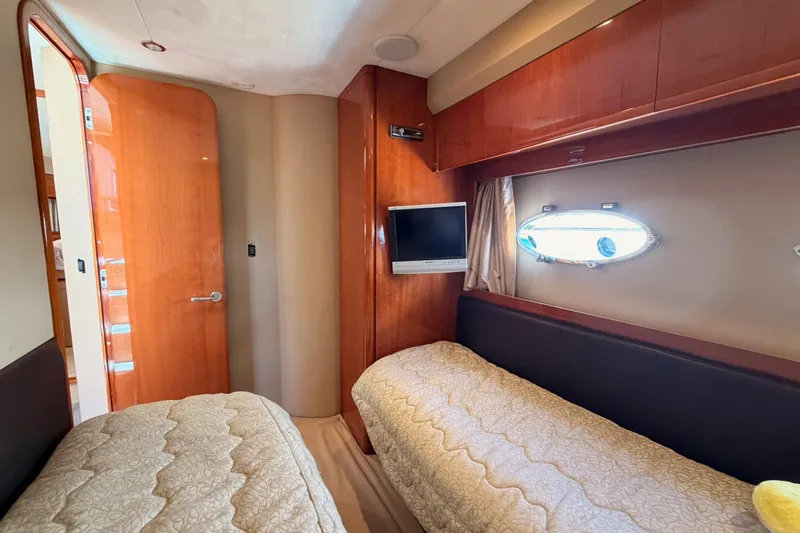 Slide: The Image of Luxurious 2007 Viking Princess 54 Flybridge cabin with twin beds and elegant wood finishes. - 53