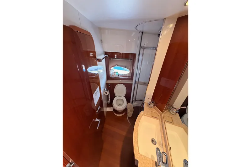Slide: The Image of Luxurious bathroom in 2007 Viking Princess 54 Flybridge yacht with dual sinks and shower. - 54