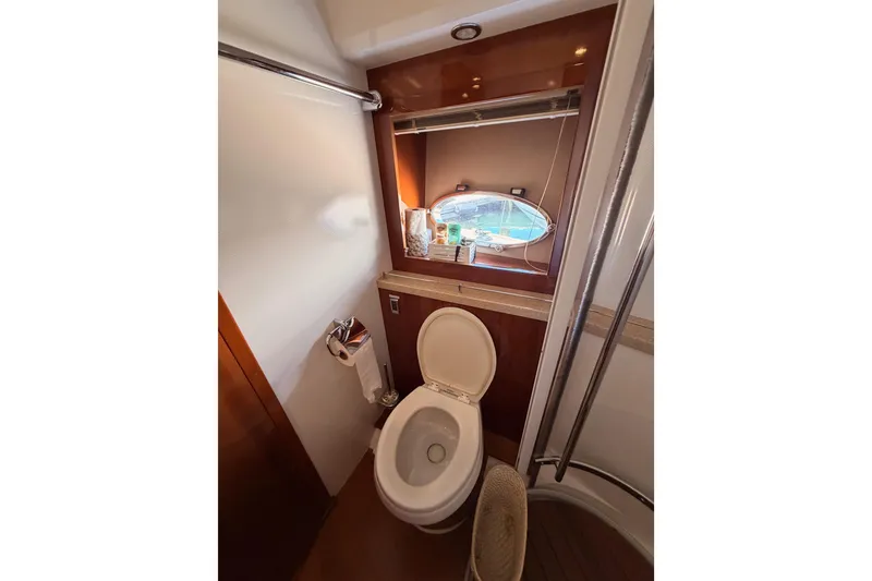 Slide: The Image of Luxurious bathroom in 2007 Viking Princess 54 Flybridge yacht with porthole view. - 56