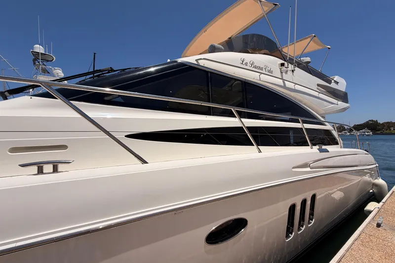 Slide: The Image of 2007 Viking Princess 54 Flybridge yacht docked, featuring sleek design and luxurious amenities. - 6