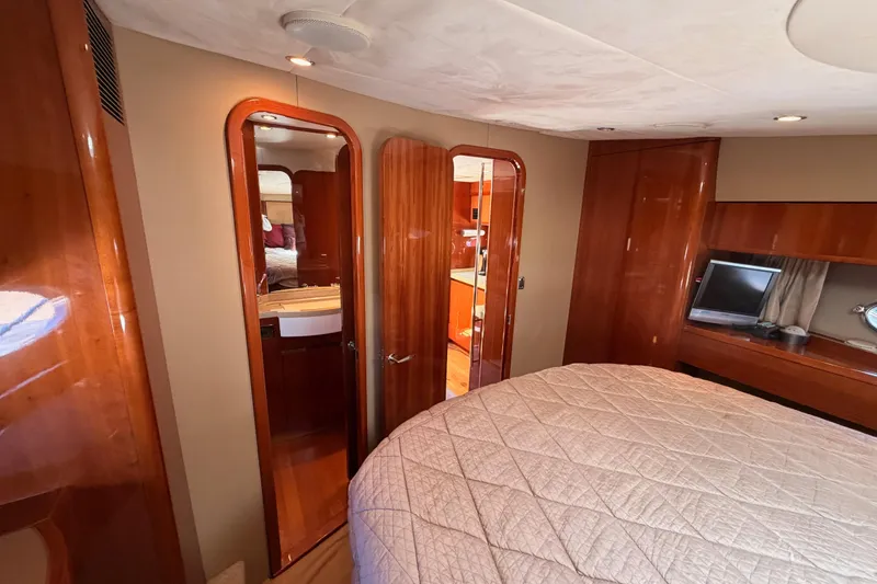 Slide: The Image of Luxurious interior of 2007 Viking Princess 54 Flybridge yacht with wood finishes and cozy bedroom. - 62
