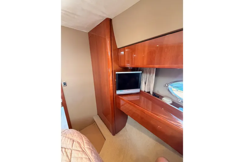 Slide: The Image of Luxurious interior of 2007 Viking Princess 54 Flybridge yacht with wood cabinetry and TV. - 64