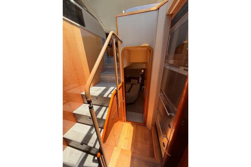 Slide: The Image of Interior staircase of 2007 Viking Princess 54 Flybridge yacht, featuring elegant wood finishes. - 66