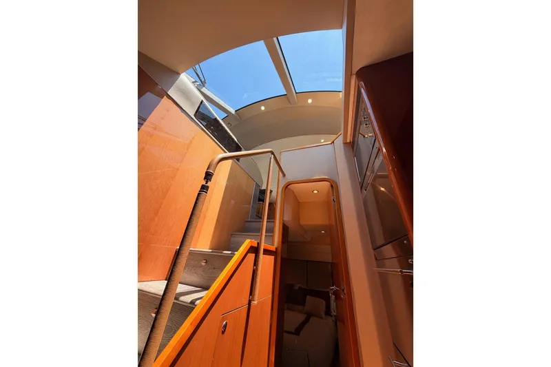 Slide: The Image of Interior view of 2007 Viking Princess 54 Flybridge yacht with skylight and wooden staircase. - 78