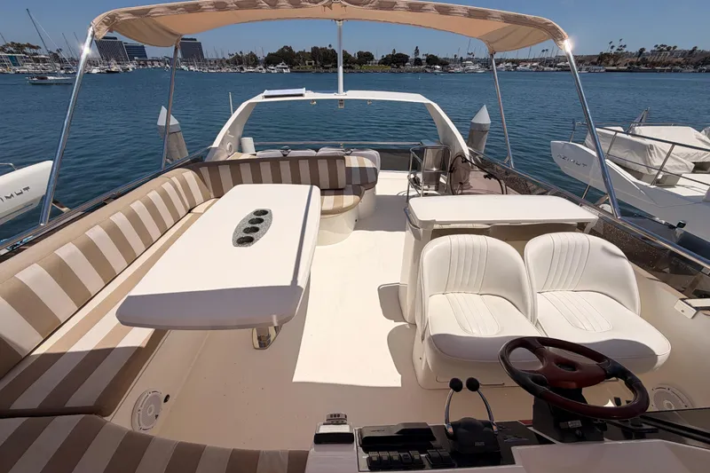 Slide: The Image of Flybridge of 2007 Viking Princess 54, featuring spacious seating and helm, docked in a marina. - 82