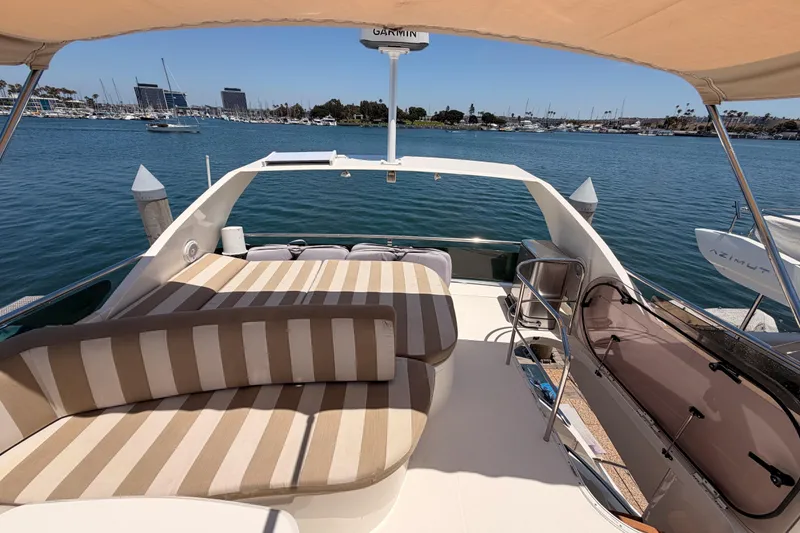 Slide: The Image of Luxurious 2007 Viking Princess 54 Flybridge yacht with spacious sun deck and marina view. - 84