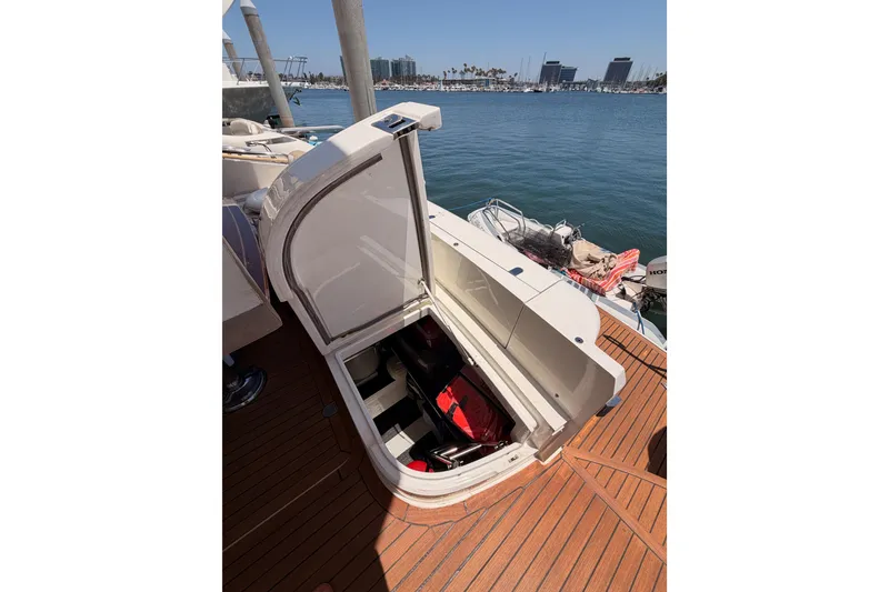 Slide: The Image of Open storage compartment on 2007 Viking Princess 54 Flybridge yacht, docked by the marina. - 85