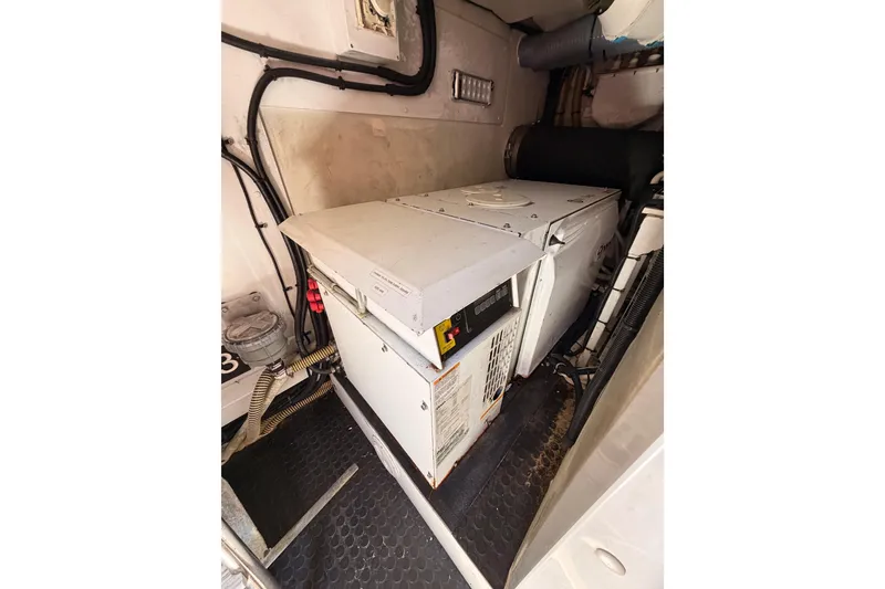 Slide: The Image of Engine room of 2007 Viking Princess 54 Flybridge yacht, featuring generator and wiring. - 87