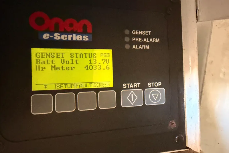 Slide: The Image of Onan e-Series generator display showing battery voltage and hour meter on Viking Princess 54 Flybridge. - 89