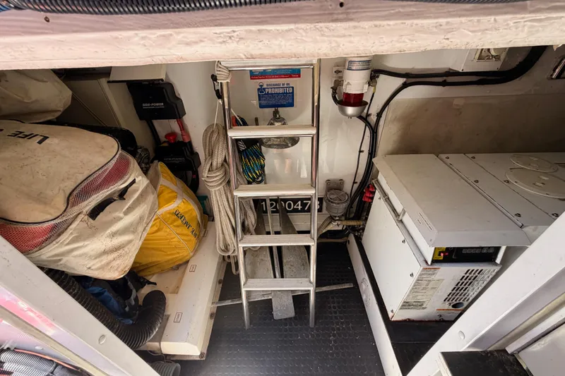 Slide: The Image of Engine room of 2007 Viking Princess 54 Flybridge with equipment and storage items. - 90