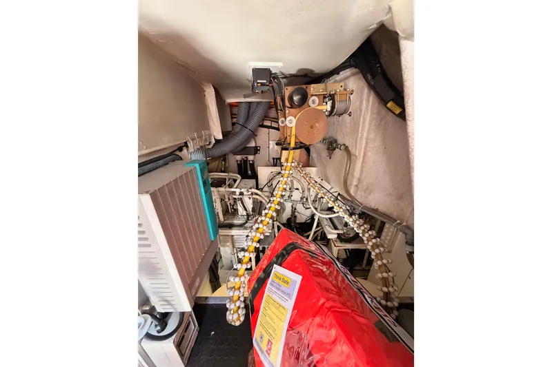 Slide: The Image of Engine room of 2007 Viking Princess 54 Flybridge yacht, showcasing mechanical components and equipment. - 91