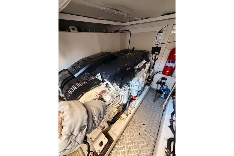 Slide: The Image of Engine room of 2007 Viking Princess 54 Flybridge yacht, featuring Volvo engine and fire extinguisher. - 95