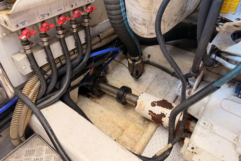 Slide: The Image of Engine room of 2007 Viking Princess 54 Flybridge with visible hoses and mechanical components. - 98