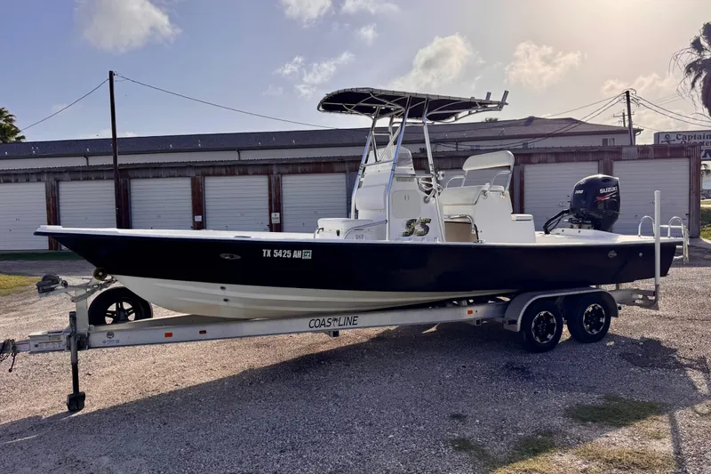 The Image of 2006 South Shore 26 boat on trailer with Suzuki outboard motor, parked outdoors. - 0