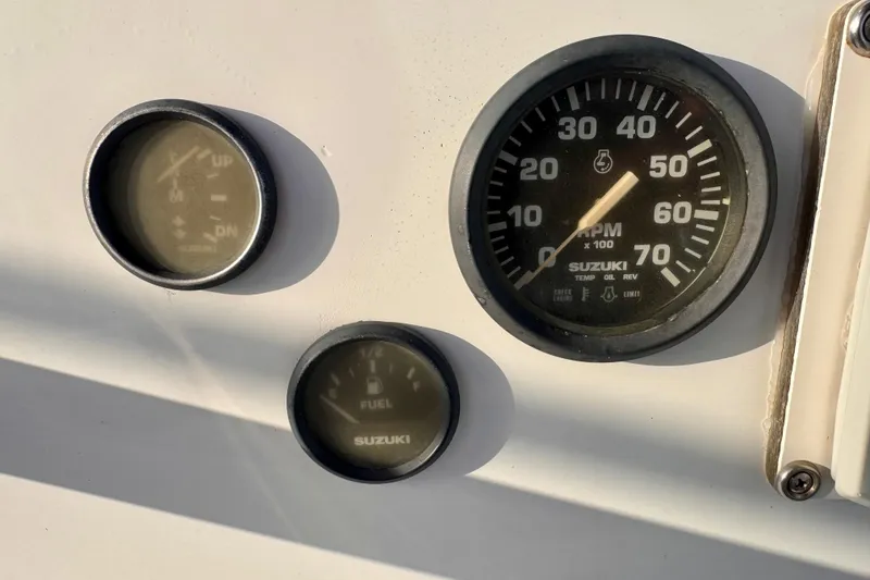 Slide: The Image of Close-up of South Shore 26 boat gauges, featuring Suzuki RPM and fuel indicators, 2006 model. - 10