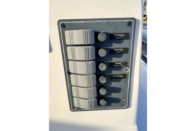 Slide: The Image of Control panel of a 2006 South Shore 26 boat with labeled switches. - 11