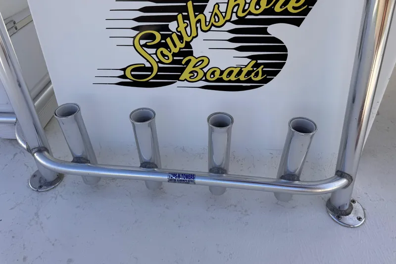 Slide: The Image of Boat rod holders on a South Shore 26, 2006 model, with logo in background. - 13