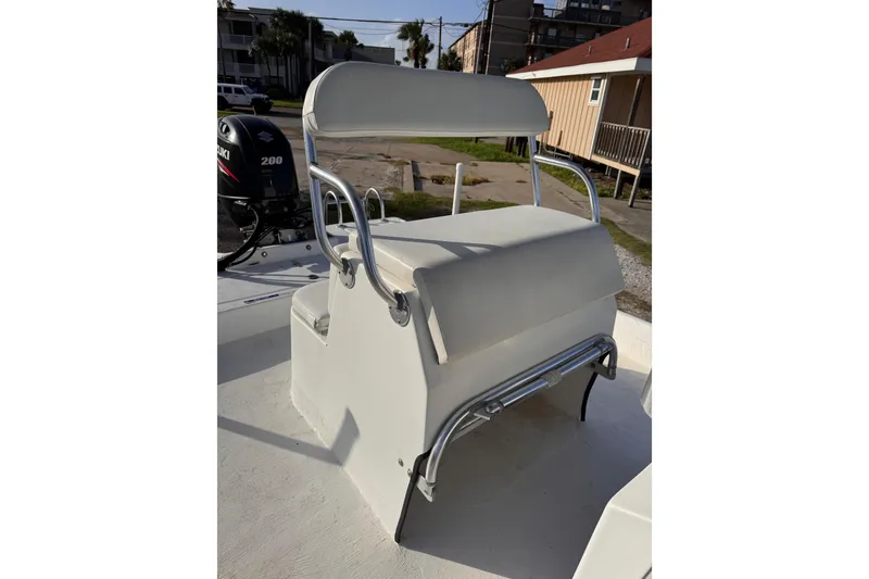 Slide: The Image of 2006 South Shore 26 boat with Suzuki 200 engine, featuring a white cushioned seat. - 14