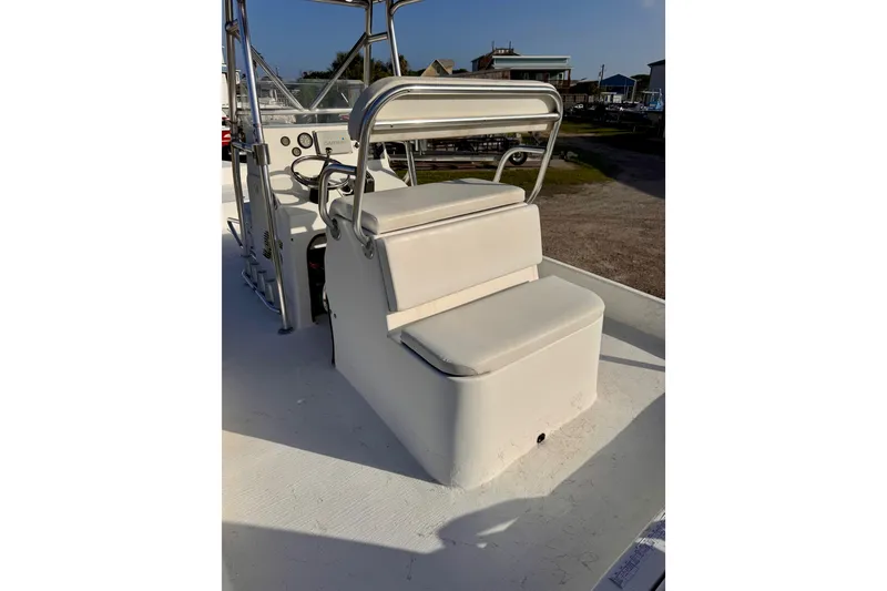 Slide: The Image of 2006 South Shore 26 boat interior with white seating and steering console. - 15