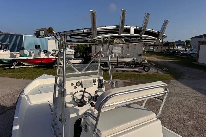 Slide: The Image of 2006 South Shore 26 boat with T-top and Garmin navigation, parked in a marina. - 17