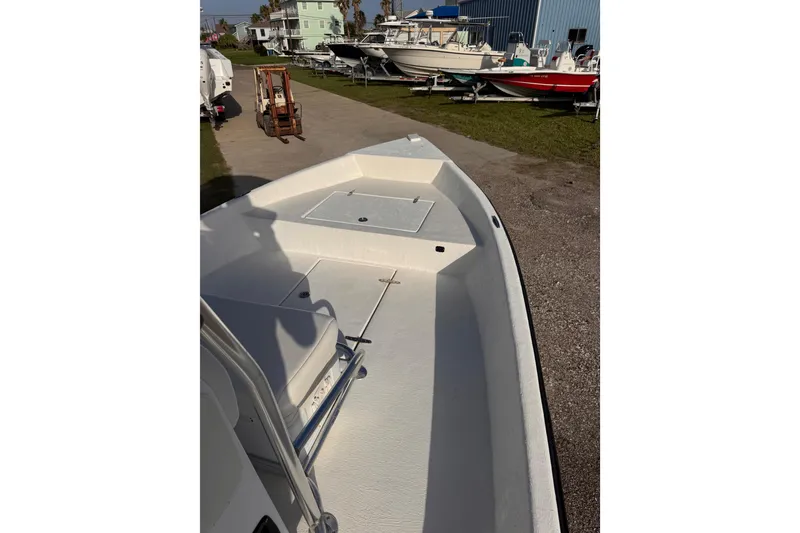 Slide: The Image of 2006 South Shore 26 boat deck, parked outdoors with other boats nearby. - 19