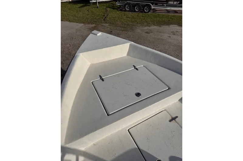 Slide: The Image of 2006 South Shore 26 boat deck with storage compartments, parked on grass. - 21