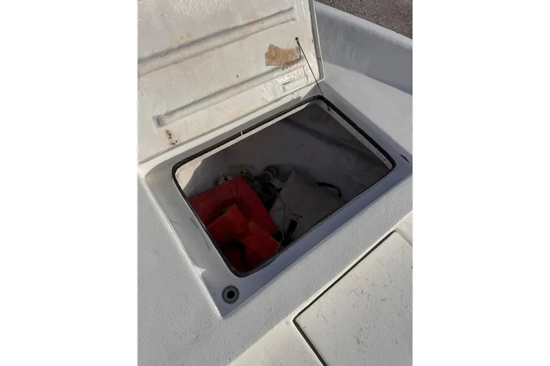 Slide: The Image of Open storage compartment on 2006 South Shore 26 boat with life jacket inside. - 22