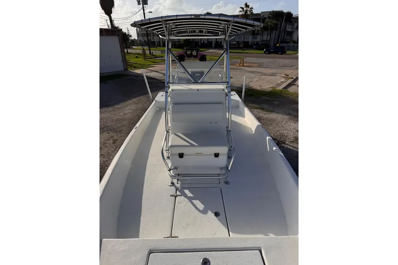 Slide: The Image of 2006 South Shore 26 boat with T-top and center console, parked on a sunny day. - 23