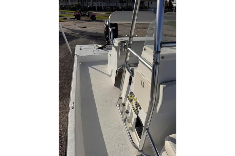Slide: The Image of 2006 South Shore 26 boat interior with steering console and seating area. - 24