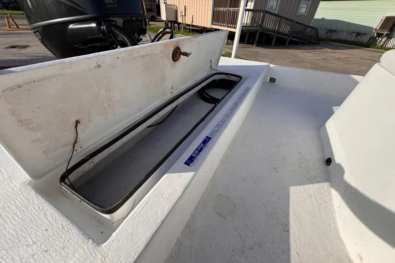 Slide: The Image of Open storage compartment on a 2006 South Shore 26 boat, showing interior details. - 27