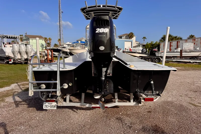 Slide: The Image of Rear view of a 2006 South Shore 26 boat with a 200 HP engine. - 4