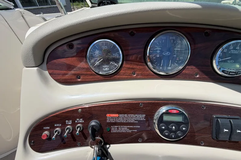 Slide: The Image of Dashboard of a 2004 Sea Ray 240 Sundeck boat with gauges and controls. - 13