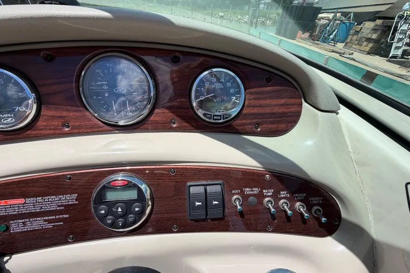 Slide: The Image of Dashboard of a 2004 Sea Ray 240 Sundeck boat with gauges and controls. - 14