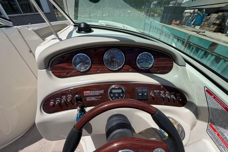 Slide: The Image of Dashboard of a 2004 Sea Ray 240 Sundeck boat with gauges and controls. - 15