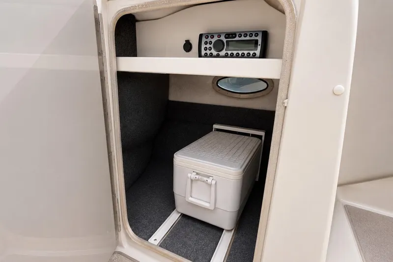 Slide: The Image of 2004 Sea Ray 240 Sundeck interior storage with cooler and stereo system. - 21